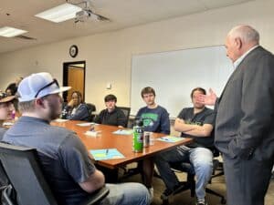 Terry Duperon talking with students