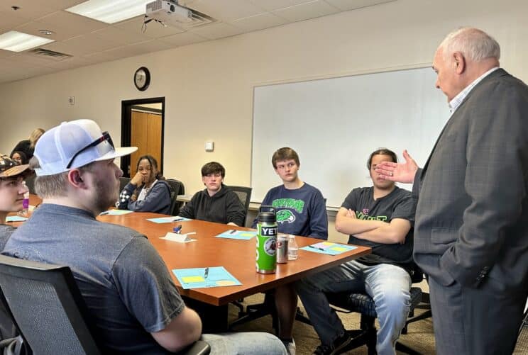 Terry Duperon talking with students